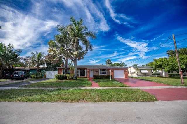 a front view of house with yard and green space