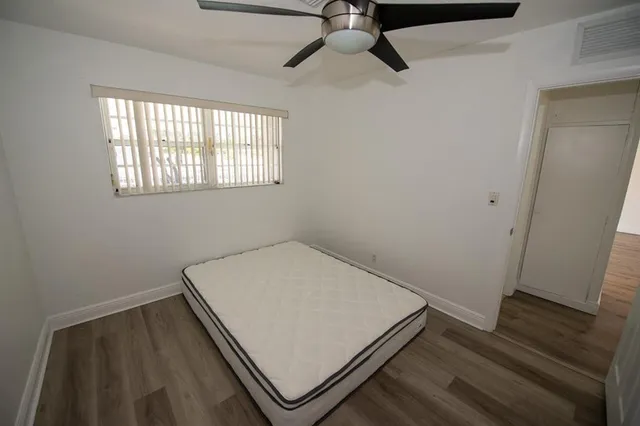 a view of a room with wooden floor and windows