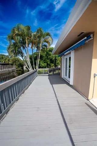 a backyard of a house with plants and outdoor seating