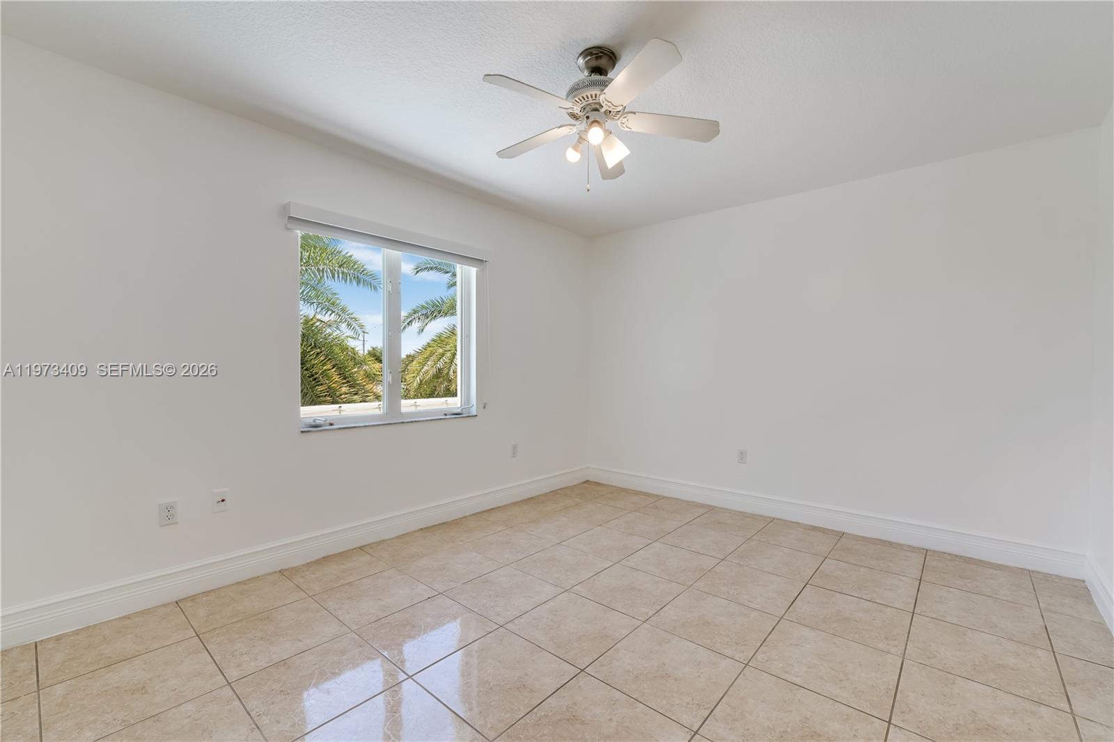 13050 Southwest 26th Street Miami, FL 33175 - Photo 19 of 43 wooden floor in an empty room with a window