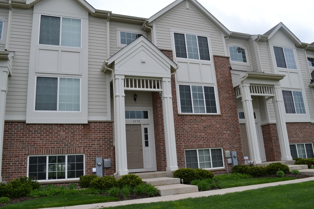 3372 Cameron Drive Elgin, IL 60124 - Photo 1 of 18 a front view of a house with garden