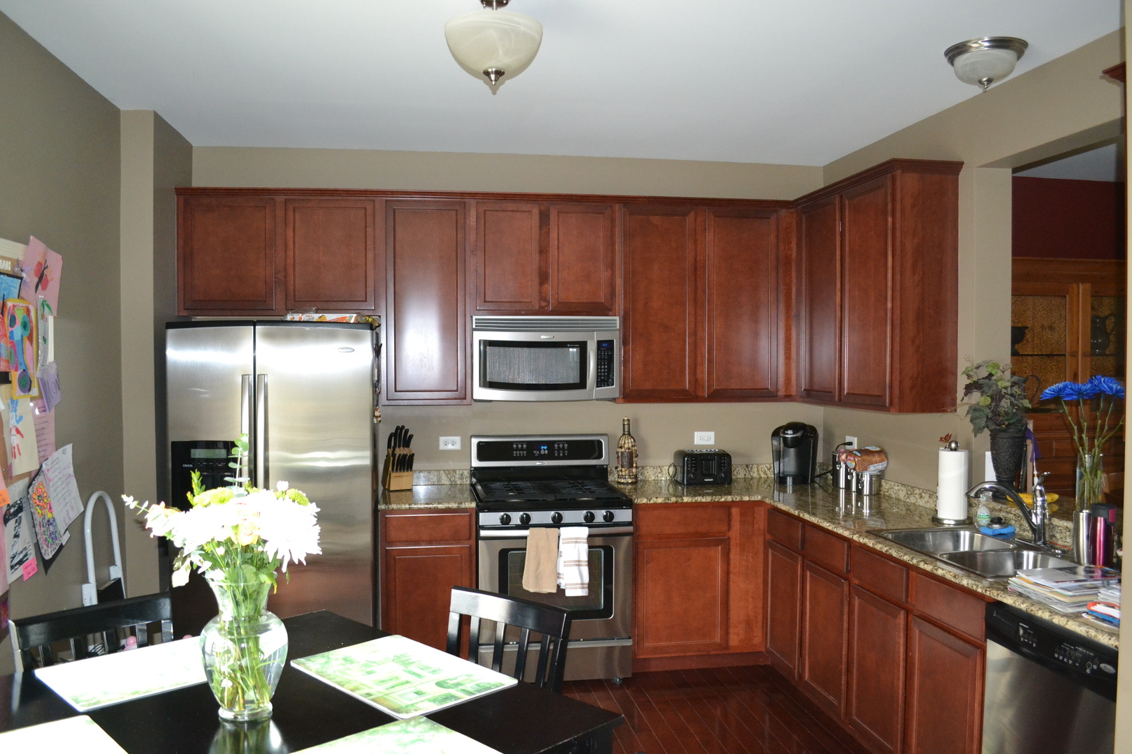 3372 Cameron Drive Elgin, IL 60124 - Photo 7 of 18 a kitchen with stainless steel appliances granite countertop a refrigerator sink and stove