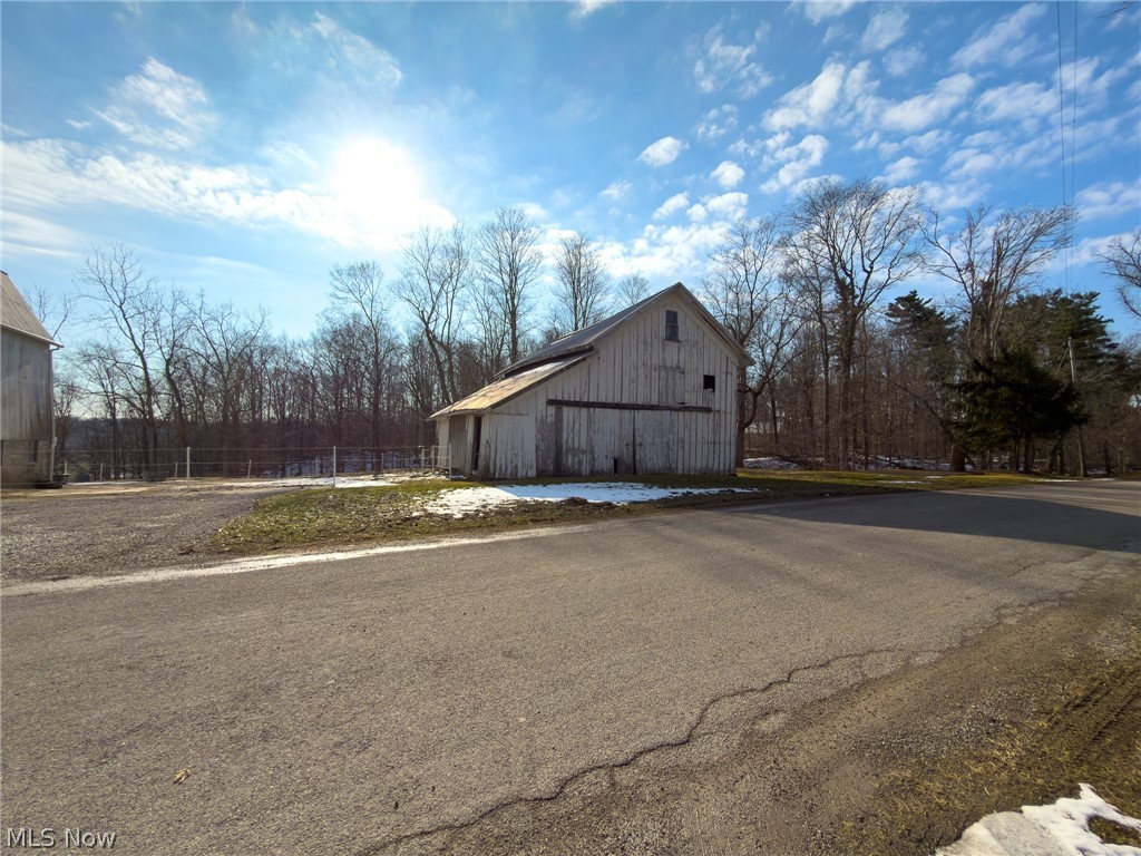 14178 West Road Wakeman, OH 44889 - Photo 5 of 35 View of side of home featuring a barn and an outdoor structure