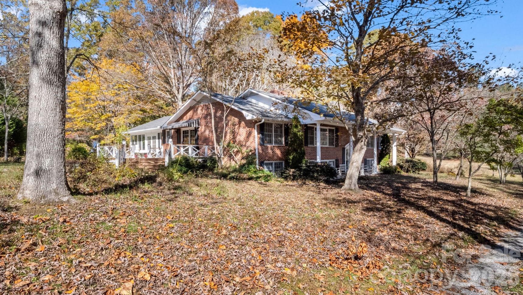a view of a house with a tree in the yard
