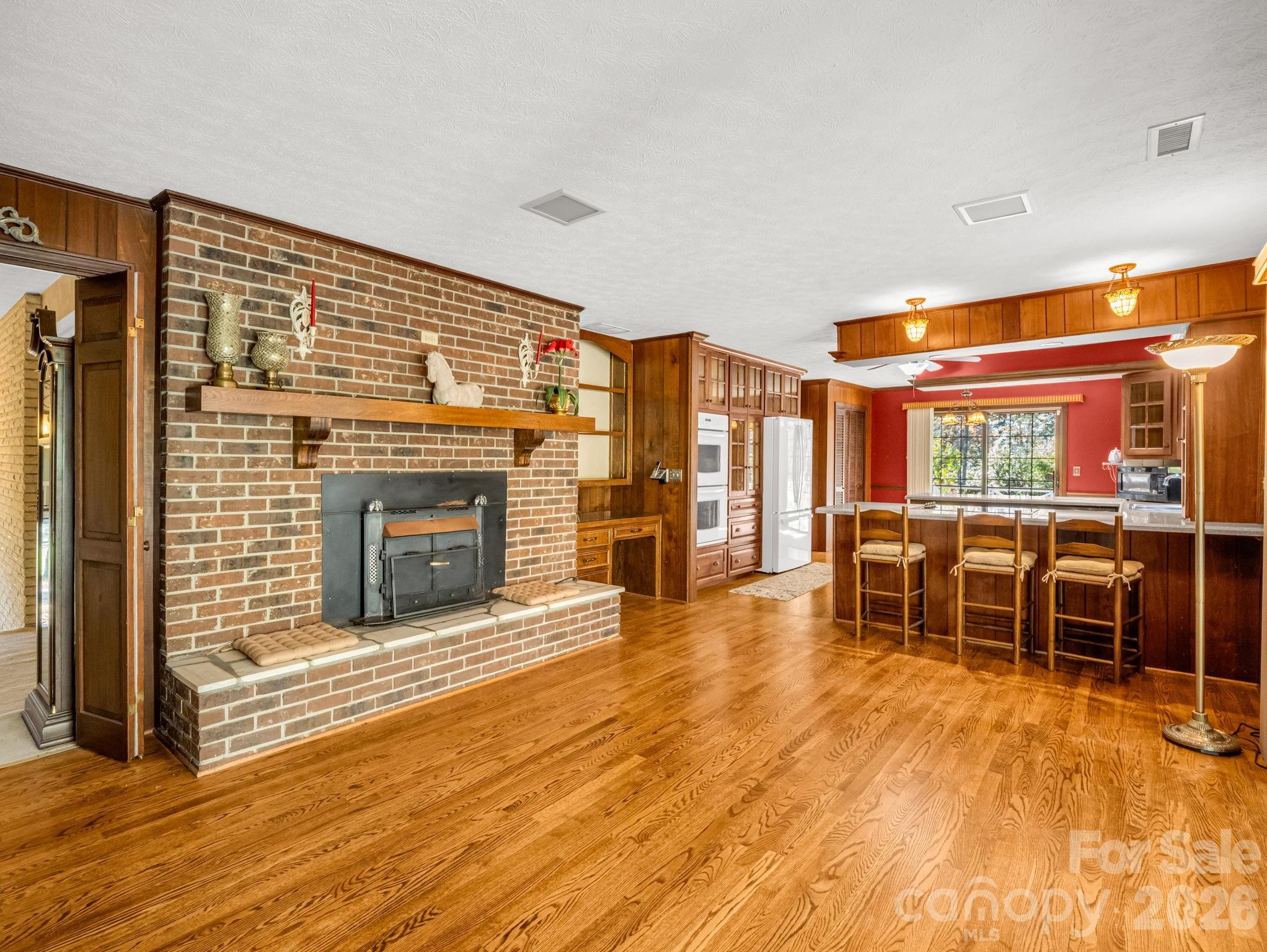 1867 Fruitland Road Hendersonville, NC 28792 - Photo 15 of 45 a living room with furniture a fireplace and wooden floor