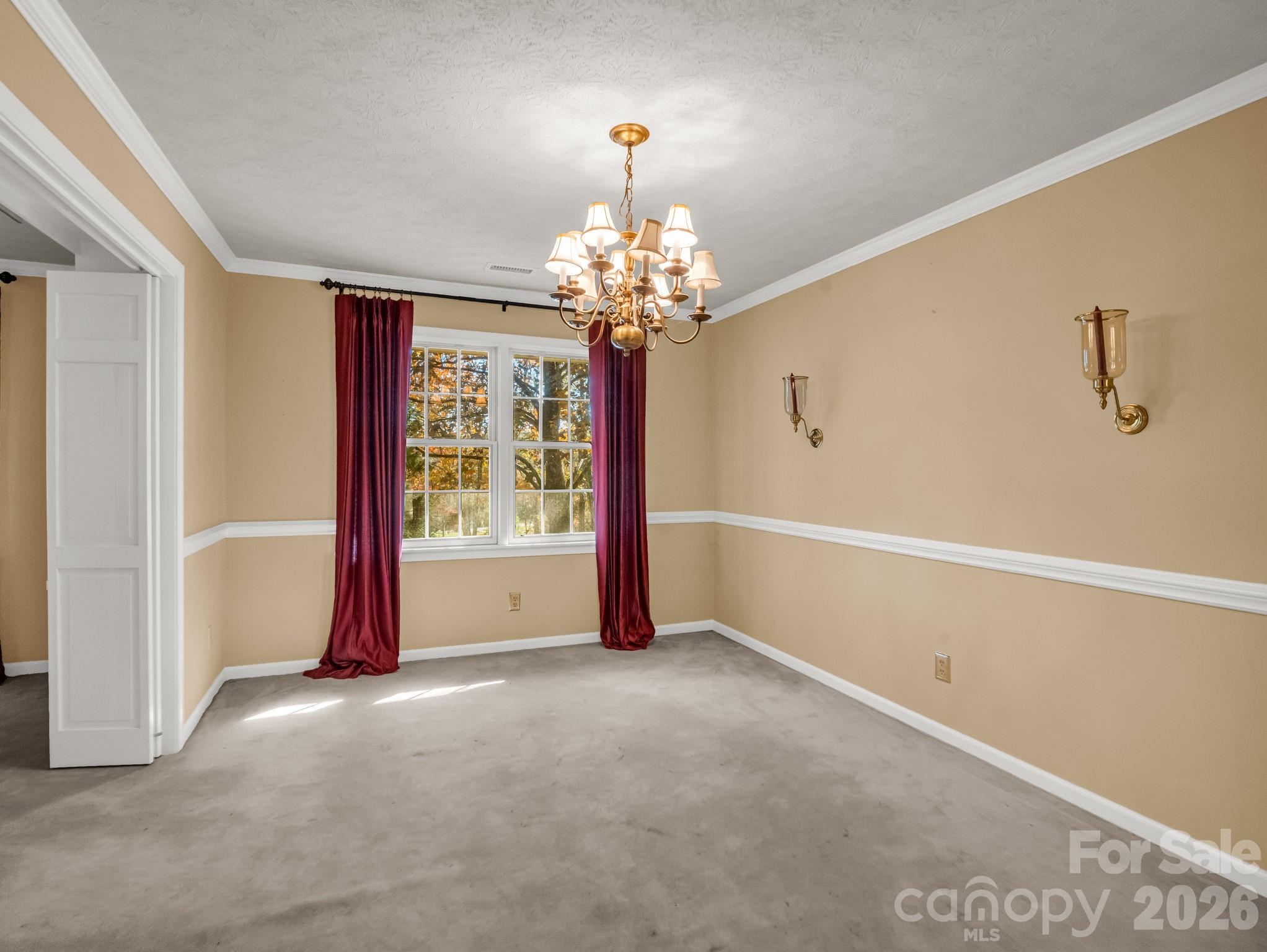 1867 Fruitland Road Hendersonville, NC 28792 - Photo 18 of 45 a view of a livingroom with a chandelier curtains and large windows
