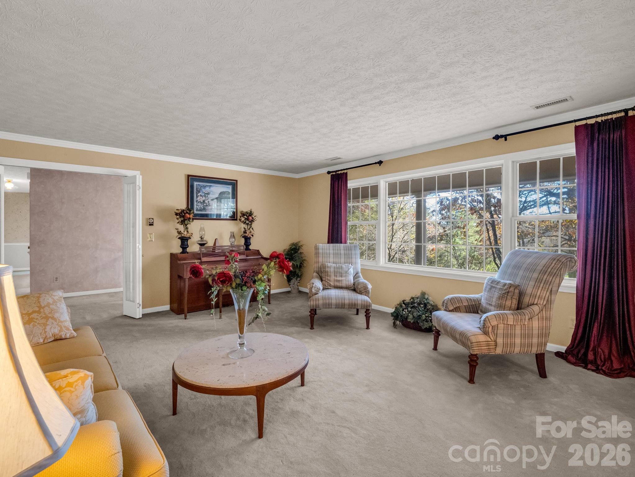 1867 Fruitland Road Hendersonville, NC 28792 - Photo 21 of 45 a living room with furniture and a large window