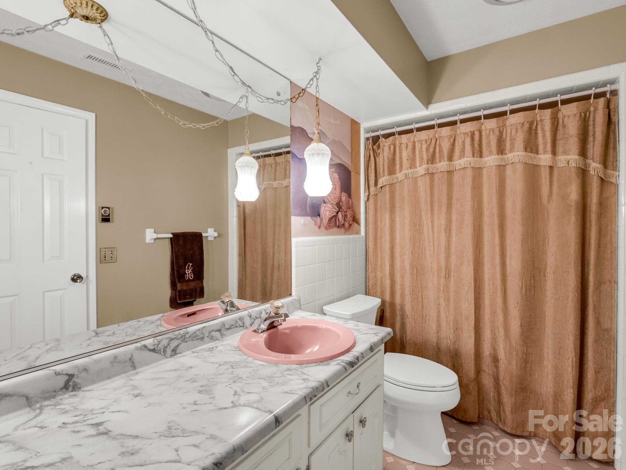 1867 Fruitland Road Hendersonville, NC 28792 - Photo 26 of 47 a bathroom with a granite countertop sink and a mirror