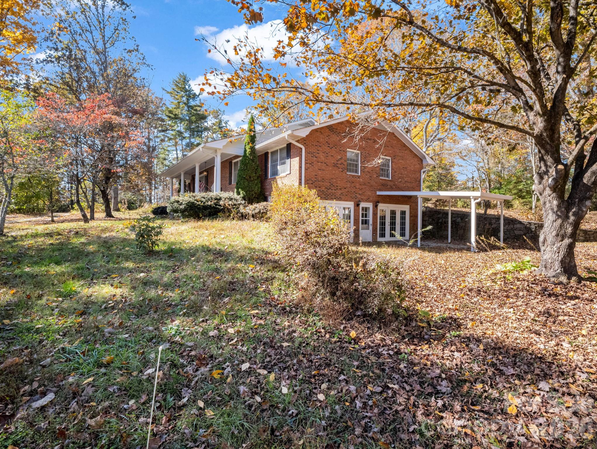 1867 Fruitland Road Hendersonville, NC 28792 - Photo 3 of 47 a front view of a house with a yard