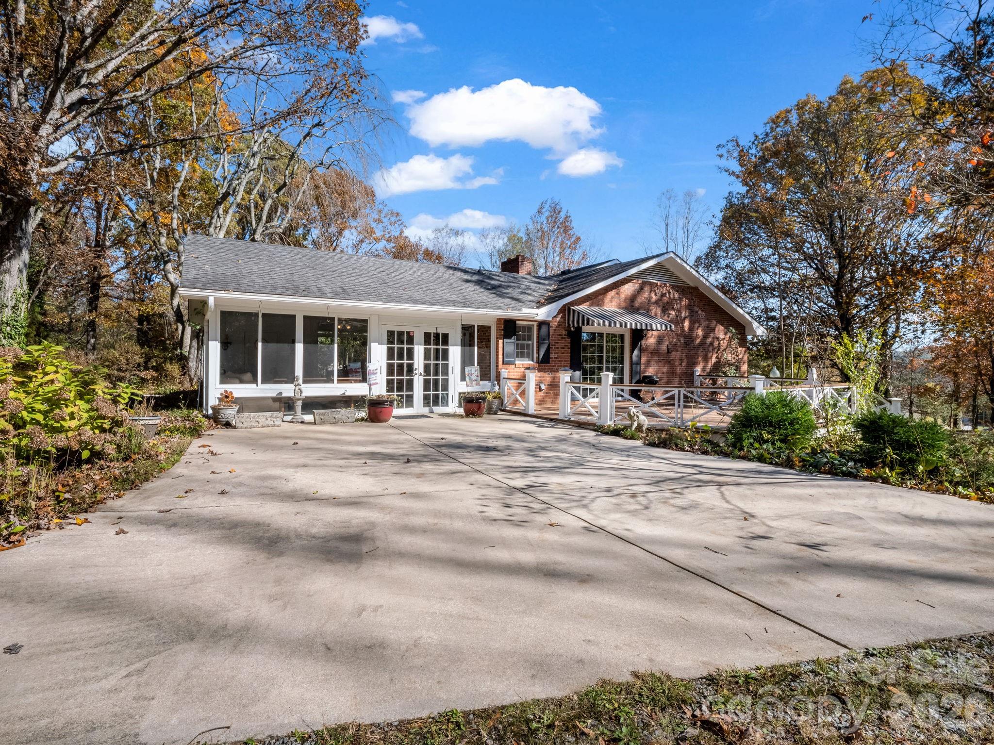 1867 Fruitland Road Hendersonville, NC 28792 - Photo 4 of 47 a front view of a building with a garden and trees