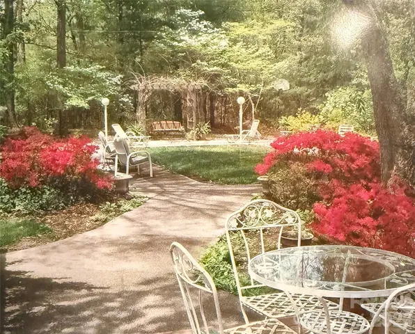 a view of yard with swimming pool and sitting area