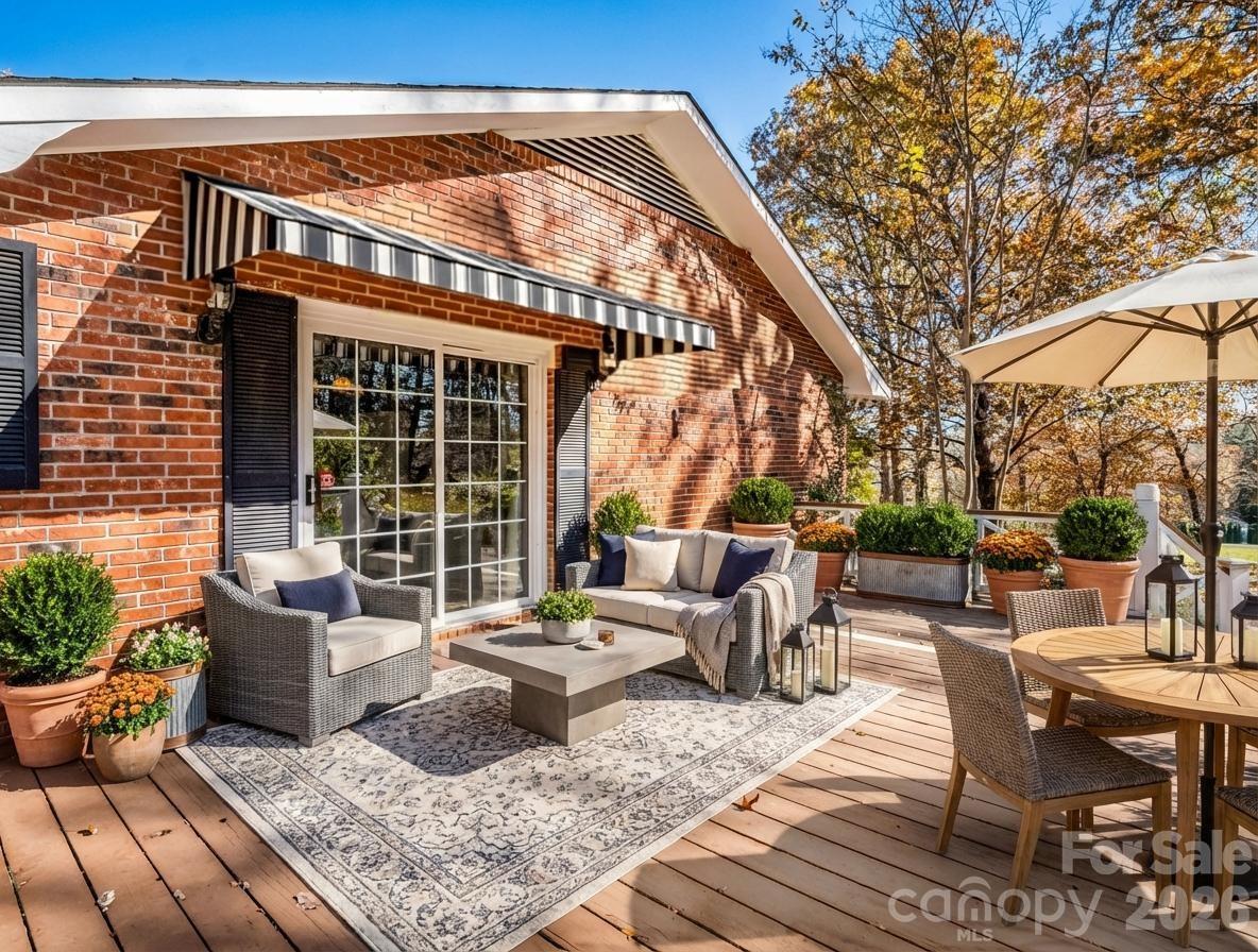 1867 Fruitland Road Hendersonville, NC 28792 - Photo 6 of 47 a view of a patio with couches table and chairs and potted plants