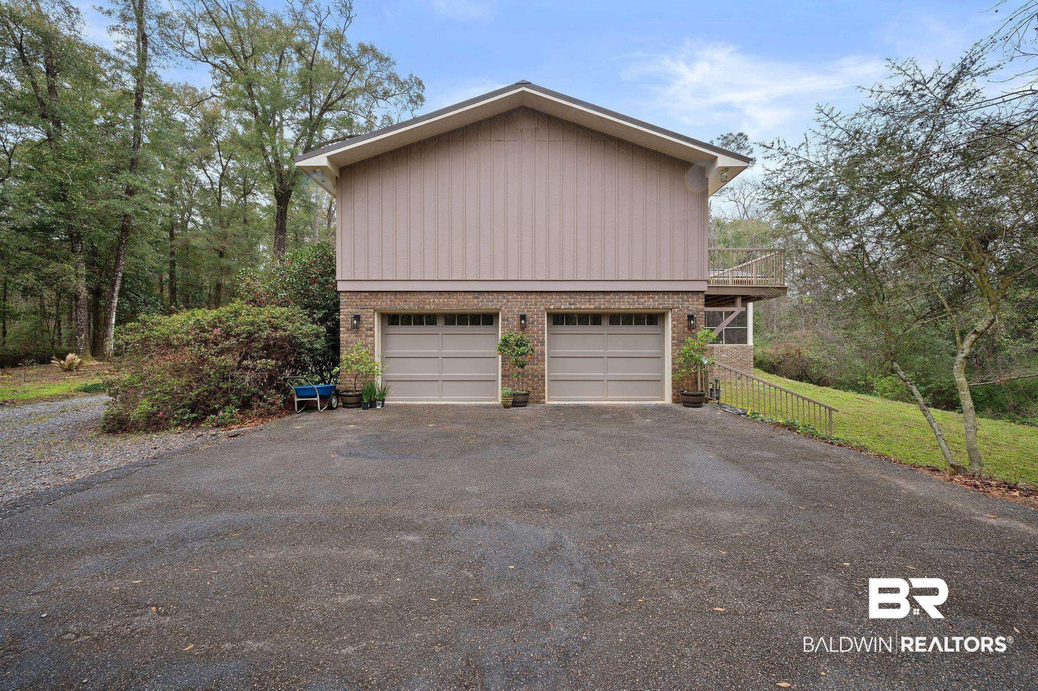 7850 Yorkhaven Road Mobile, AL 36695 - Photo 47 of 57 Exterior space featuring a garage and brick siding