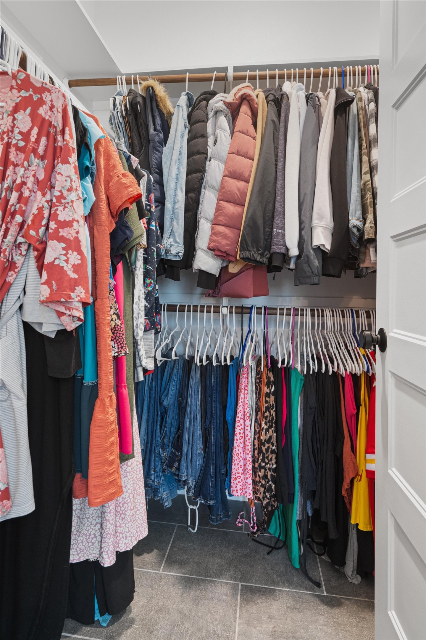 136 Fawn Hollow Elgin, TX 78621 - Photo 22 of 40 Walk in closet 2 featuring multi-level hanging rods, built-in shelving, and light gray tile flooring