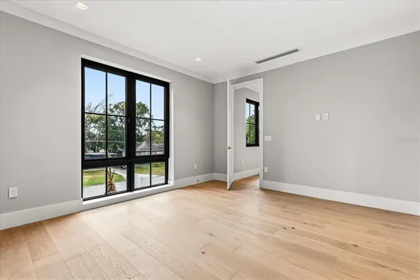 wooden floor in an empty room with a window