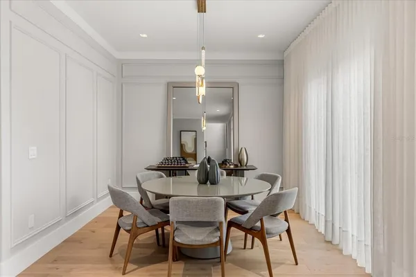a dining room with furniture and wooden floor