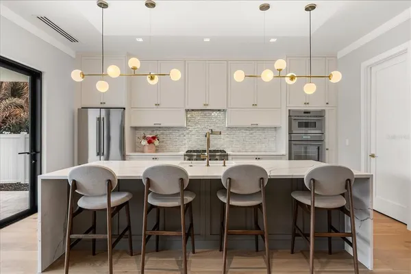 a kitchen with a sink a stove and a window