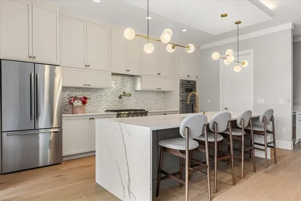 a large white kitchen with a large window