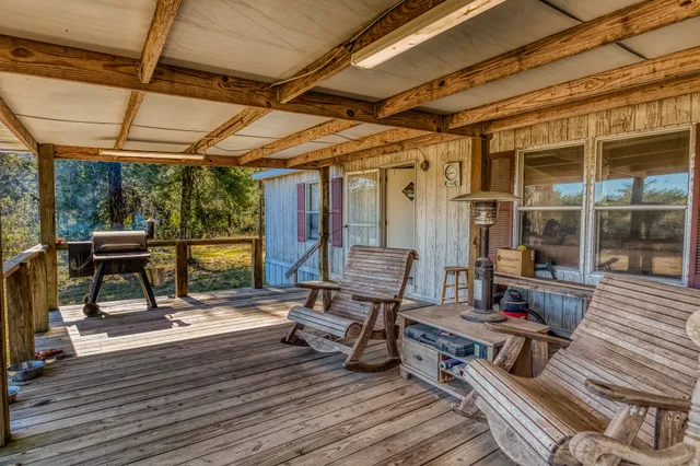 a living room with patio furniture and a wooden floor