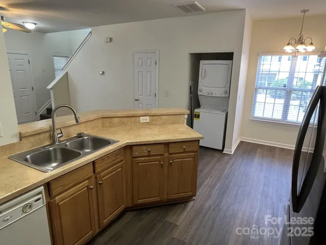 a kitchen with sink cabinets and wooden floor