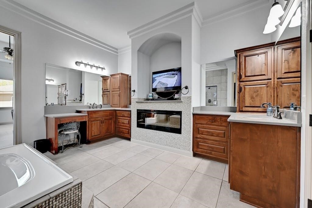 7300 Gilbert Road Manor, TX 78653 - Photo 20 of 40 a large kitchen with stainless steel appliances a stove sink and cabinets