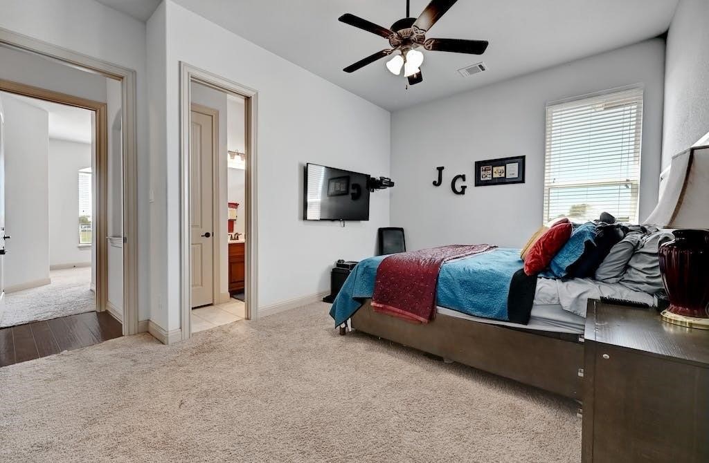 7300 Gilbert Road Manor, TX 78653 - Photo 25 of 40 a bedroom with a bed and a chandelier