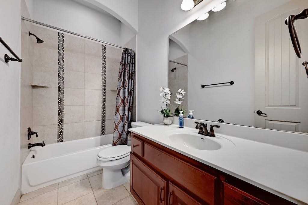 7300 Gilbert Road Manor, TX 78653 - Photo 27 of 40 a bathroom with a sink a toilet a mirror and shower