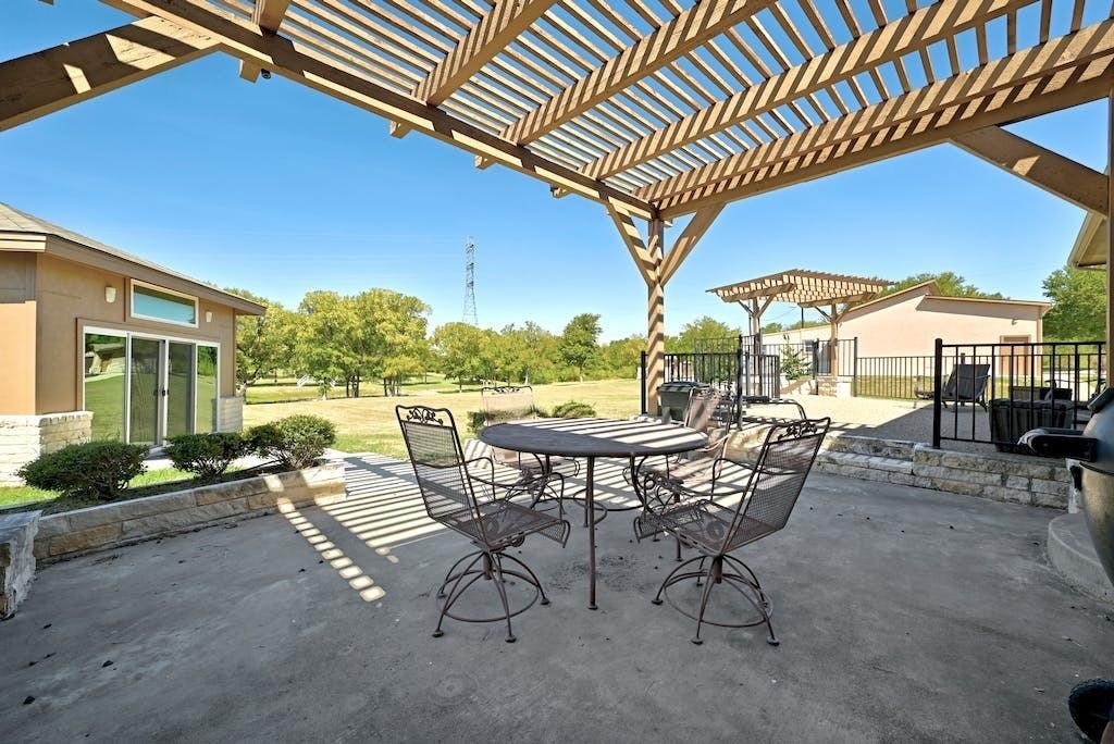 7300 Gilbert Road Manor, TX 78653 - Photo 34 of 40 a view of a patio with a table chairs and backyard