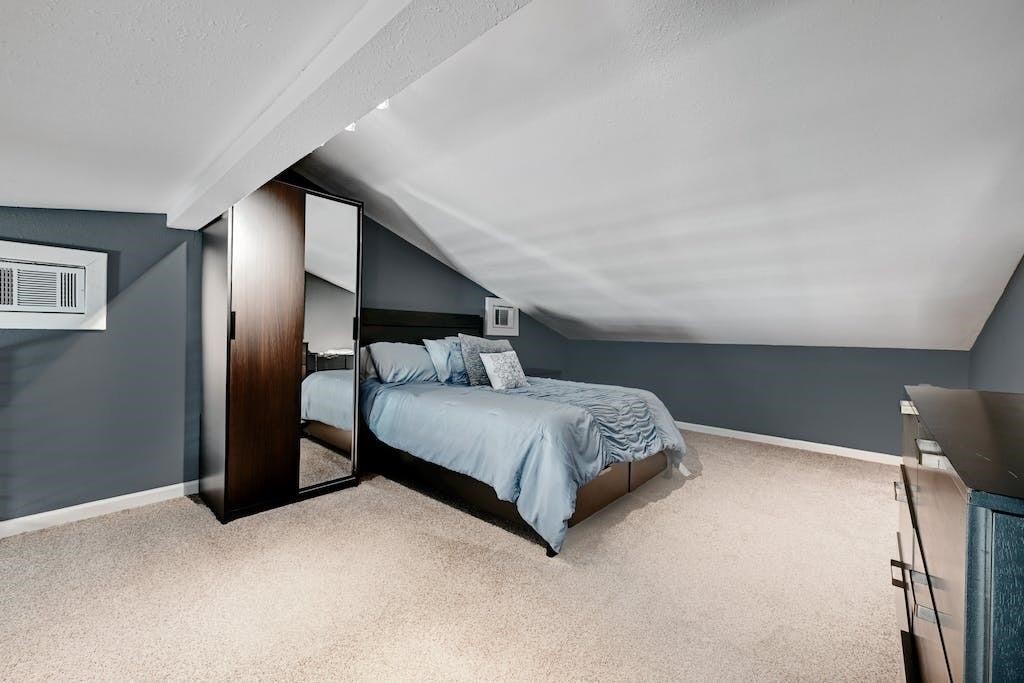 7300 Gilbert Road Manor, TX 78653 - Photo 39 of 40 a bedroom with a bed and a lamp on desk