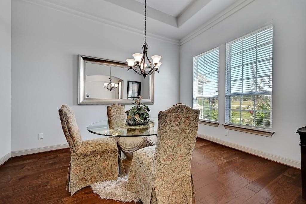 7300 Gilbert Road Manor, TX 78653 - Photo 8 of 40 a dining room with furniture a chandelier and wooden floor