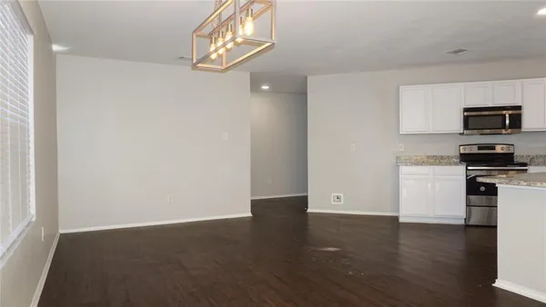 a view of kitchen with microwave and cabinets