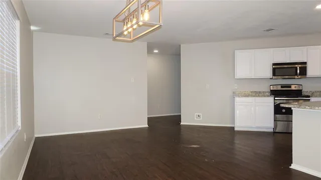 a view of kitchen with microwave and cabinets