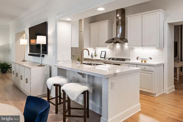 a kitchen with kitchen island a sink stove and refrigerator