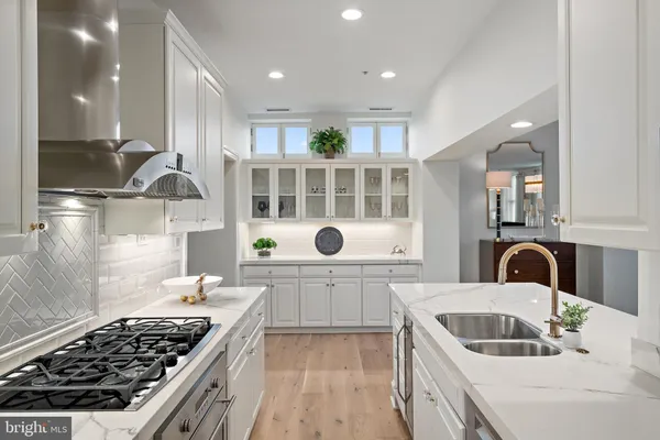 a kitchen with granite countertop a sink a stove and refrigerator