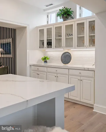 a kitchen with kitchen island granite countertop a sink and a stove