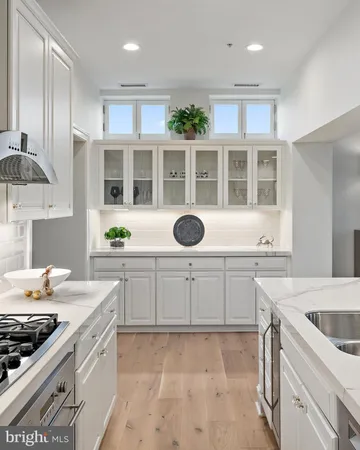 a bathroom with a sink mirror and toilet