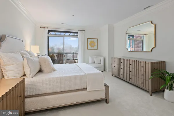 a living room with furniture a rug and white walls