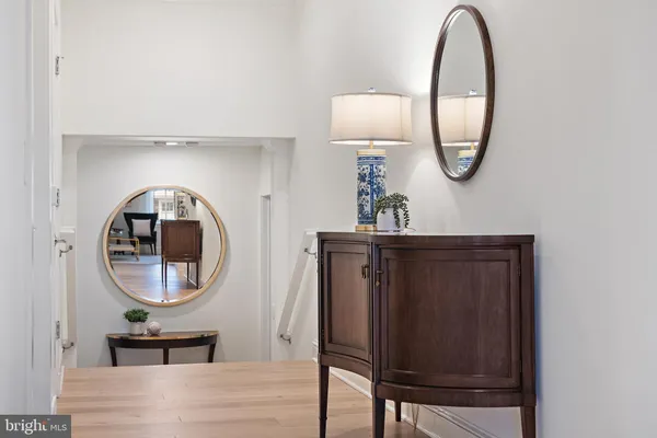 a living room with furniture a couch and a potted plant