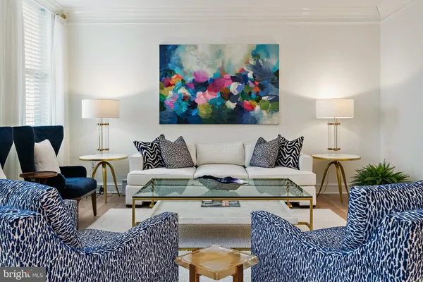 a living room with furniture a couch and a bookshelf