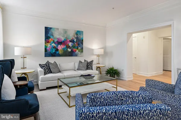 a living room with furniture plant and window