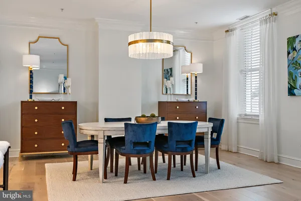 a view of a dining room with furniture and chandelier