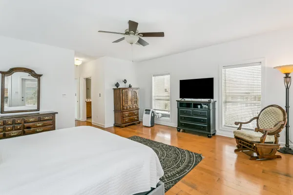 a bedroom with furniture and a flat screen tv