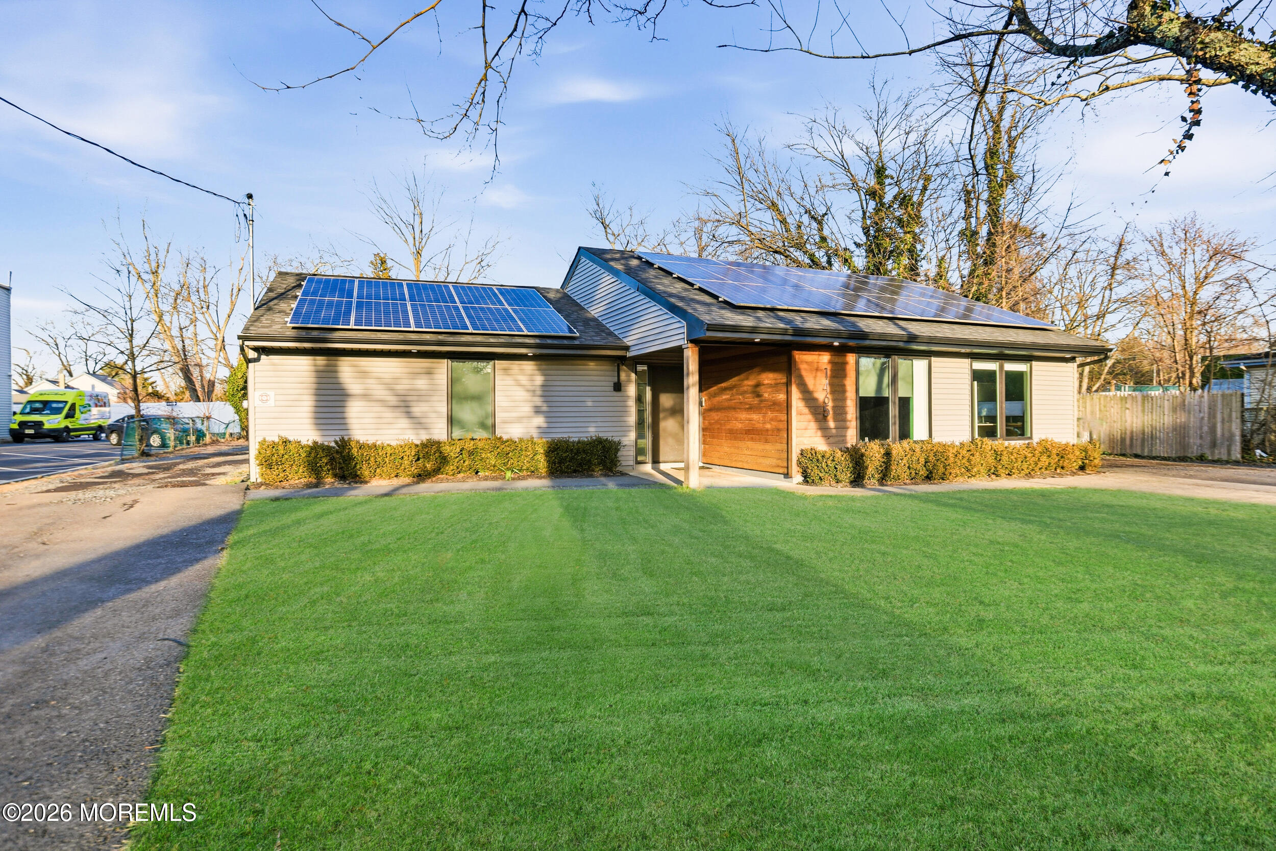 1465 Lanes Mill Road Lakewood, NJ 08701 - Photo 2 of 15 a front view of a house with a garden and yard