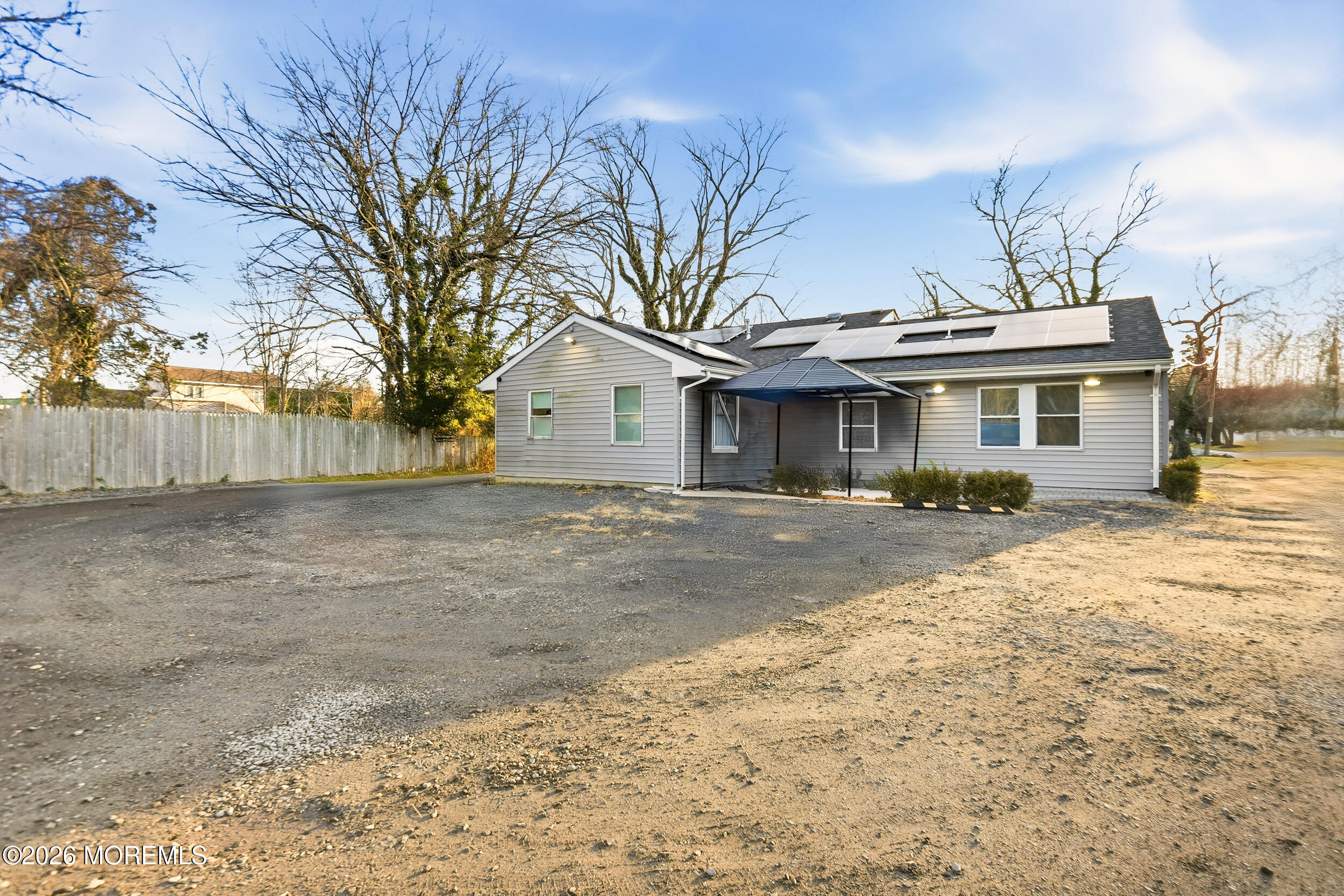 1465 Lanes Mill Road Lakewood, NJ 08701 - Photo 7 of 15 a front view of a house with a yard and garage