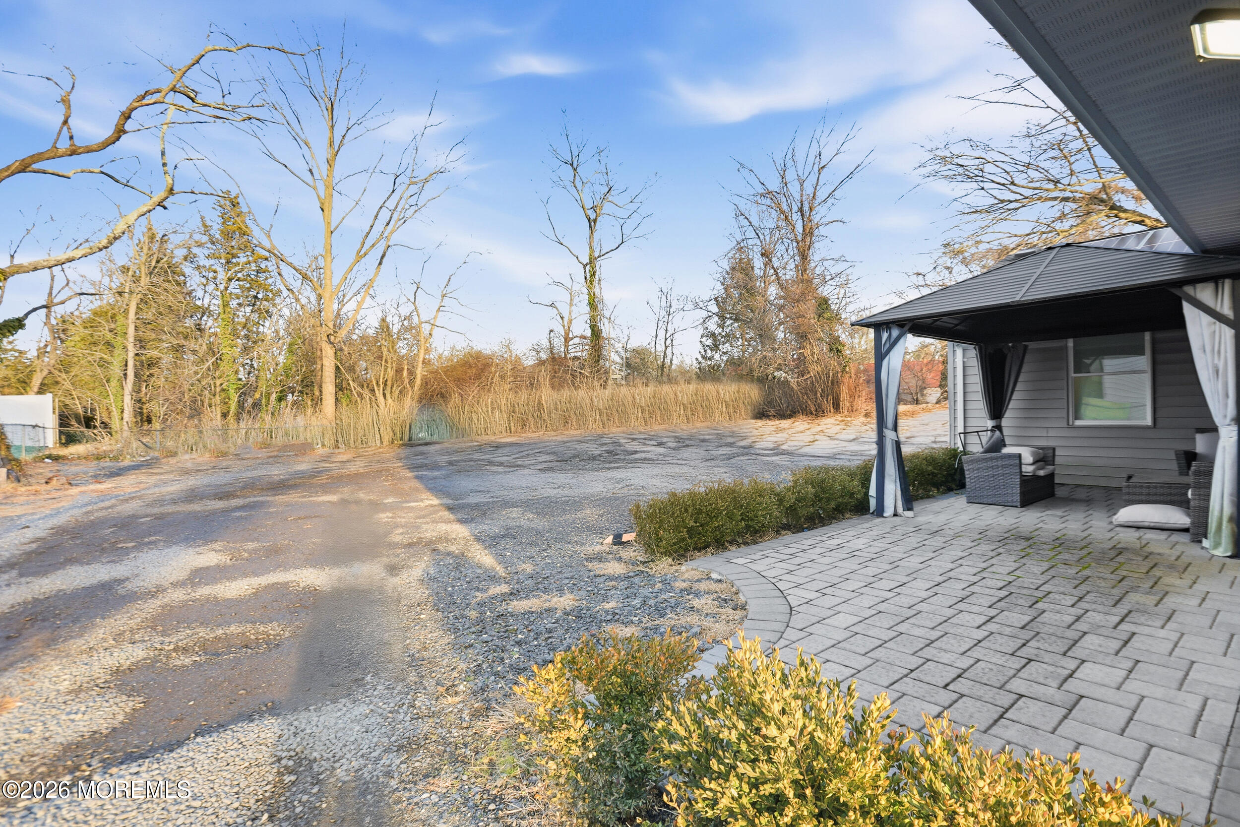 1465 Lanes Mill Road Lakewood, NJ 08701 - Photo 9 of 15 a view of a backyard with large trees