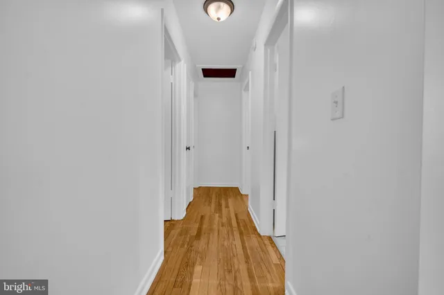 a view of a bedroom with wooden floor