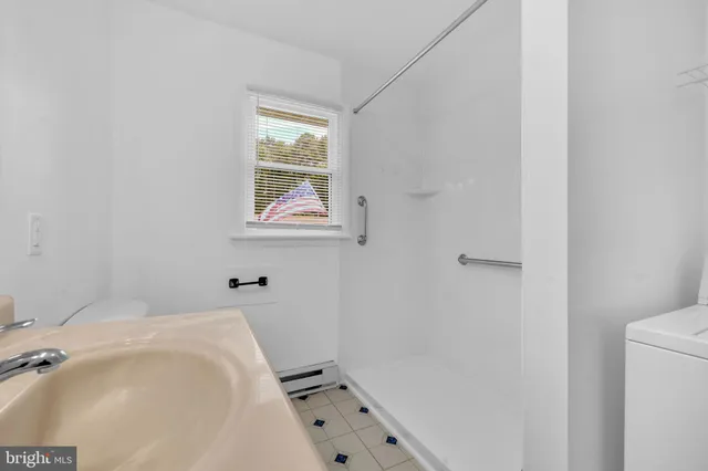 a bathroom with a bathtub and shower