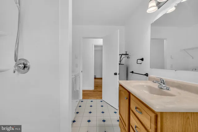 a bathroom with a sink a mirror and a shower