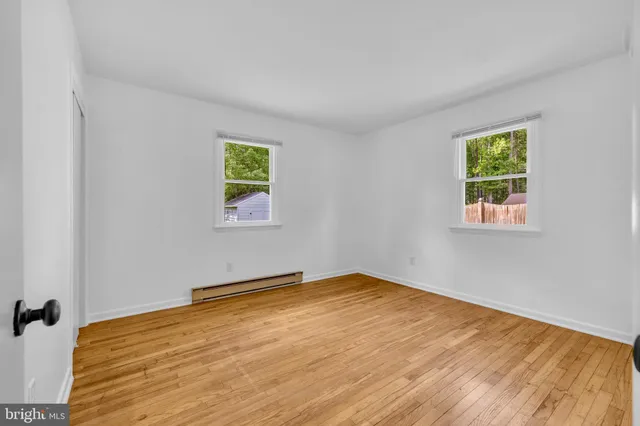 a view of room with window and wooden floor