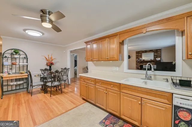 a very nice looking dining room with a large window and chandelier